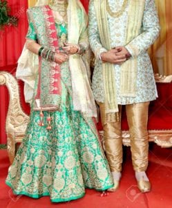 104339787 indian bride and groom pose for beautiful portraits after their colorful jaimala ceremony garlands c