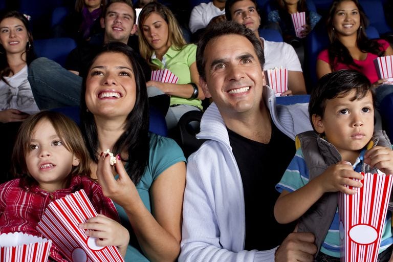 hispanic family enjoying popcorn at movie theater 136589929 59b9815f6f53ba0011dfca78